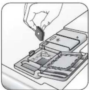Illustration of a hand inserting a small electronic component into a device tray (no text or symbols visible)