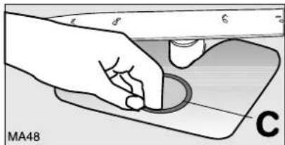 Illustration of a hand pressing down on a mechanical component (no text or symbols visible)