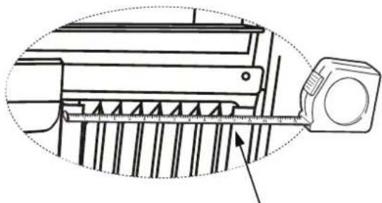 Technical line drawing of a mechanical assembly with a measuring tool (no text or symbols).