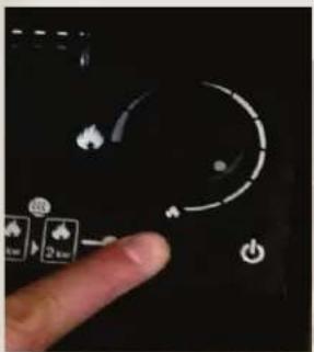 Close-up of a finger pointing at a device control panel with icons for power, battery, and settings