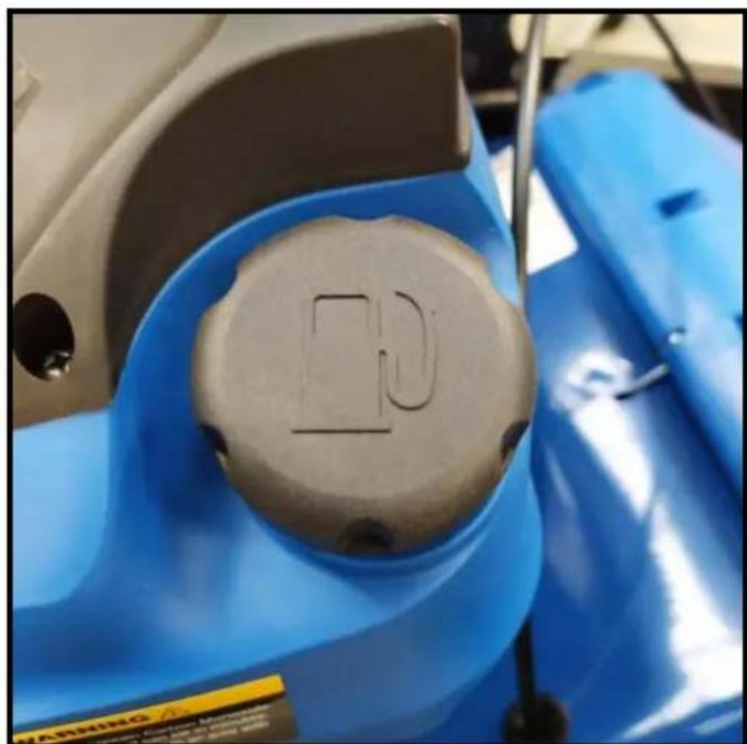 Close-up of a blue industrial machine component with a circular metallic part on top, no visible text or symbols.