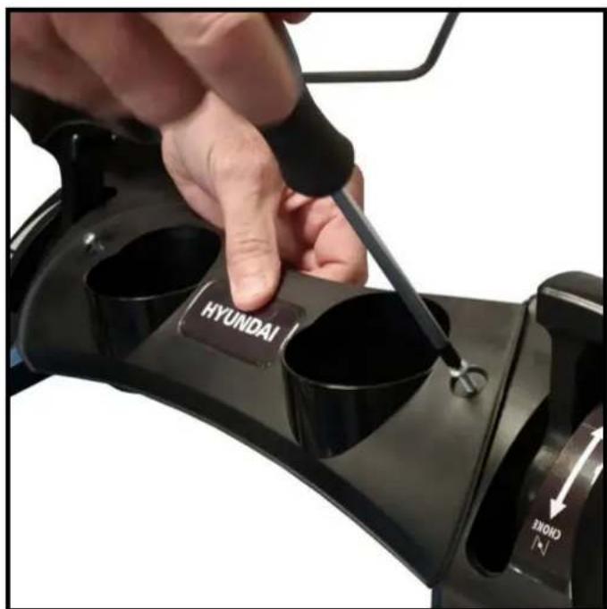 Close-up of a hand using a screwdriver to adjust or install a black automotive component with 'HYUNDAI' and 'CHINE' labels (no additional text or symbols)