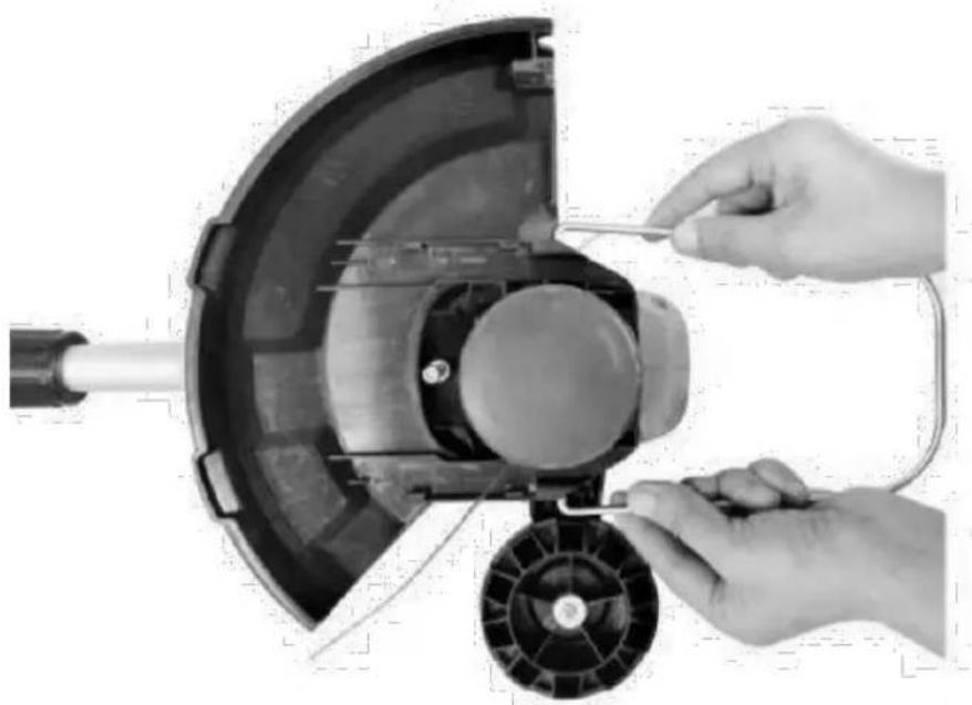 Close-up of hands operating a mechanical device with a tool inserted, showing internal components and wiring (no text or symbols visible)