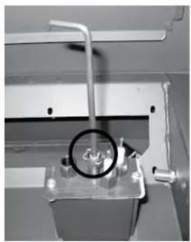 Close-up of a mechanical device with a circular inset showing a magnified view of a component (no visible text or symbols)