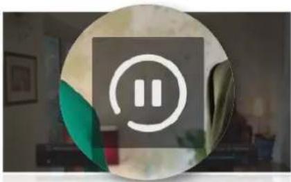 Circular icon with a white square containing two vertical bars, set against a blurred indoor background (no text or symbols)