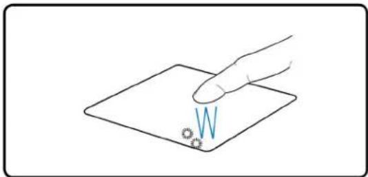 Hand pointing at a small blue letter 'W' on a flat surface, no text or symbols present