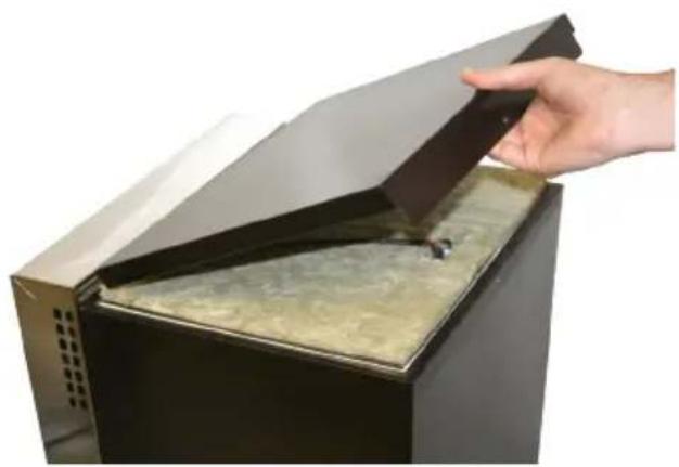 Hand placing a dark lid onto a black appliance with a glass lid, showing interior material (no text or symbols visible)