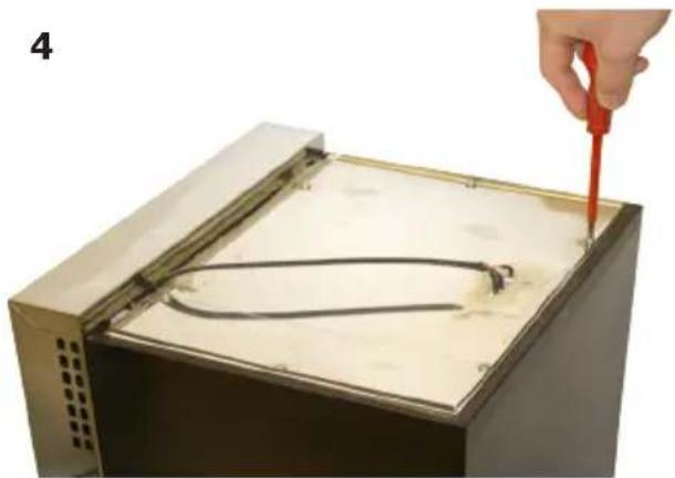 Hand using a red tool to cut or wire through a metal enclosure with a curved wire inside (no text or symbols visible)