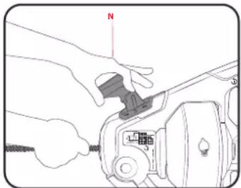 Technical diagram showing hands operating a mechanical device with labeled component 'N' and a small inset image.