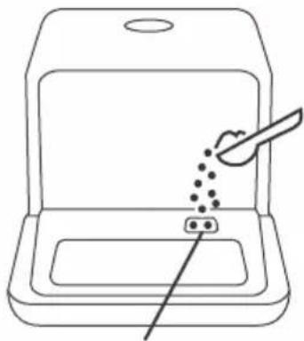 Line drawing of a food delivery tray with a spoon and a small container, no text or symbols present.