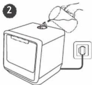 Line drawing of a hand inserting a plug into a device with an electrical outlet (no text or symbols).