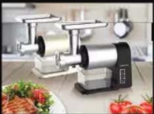 Modern kitchen electric shaver with a digital display, surrounded by fresh tomatoes and a plate of food (no visible text or symbols)