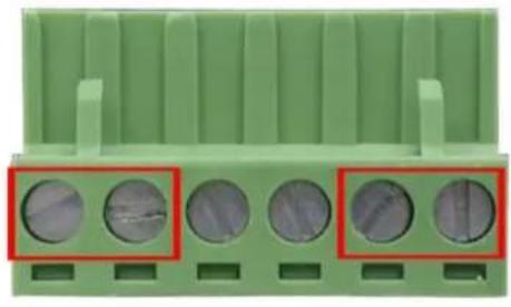 Close-up of a green plastic connector with five circular holes highlighted in red (no text or symbols visible)