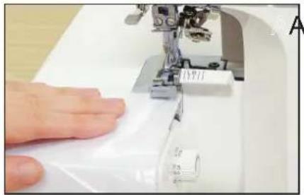 Close-up of a hand operating a sewing machine needle, no visible text or symbols