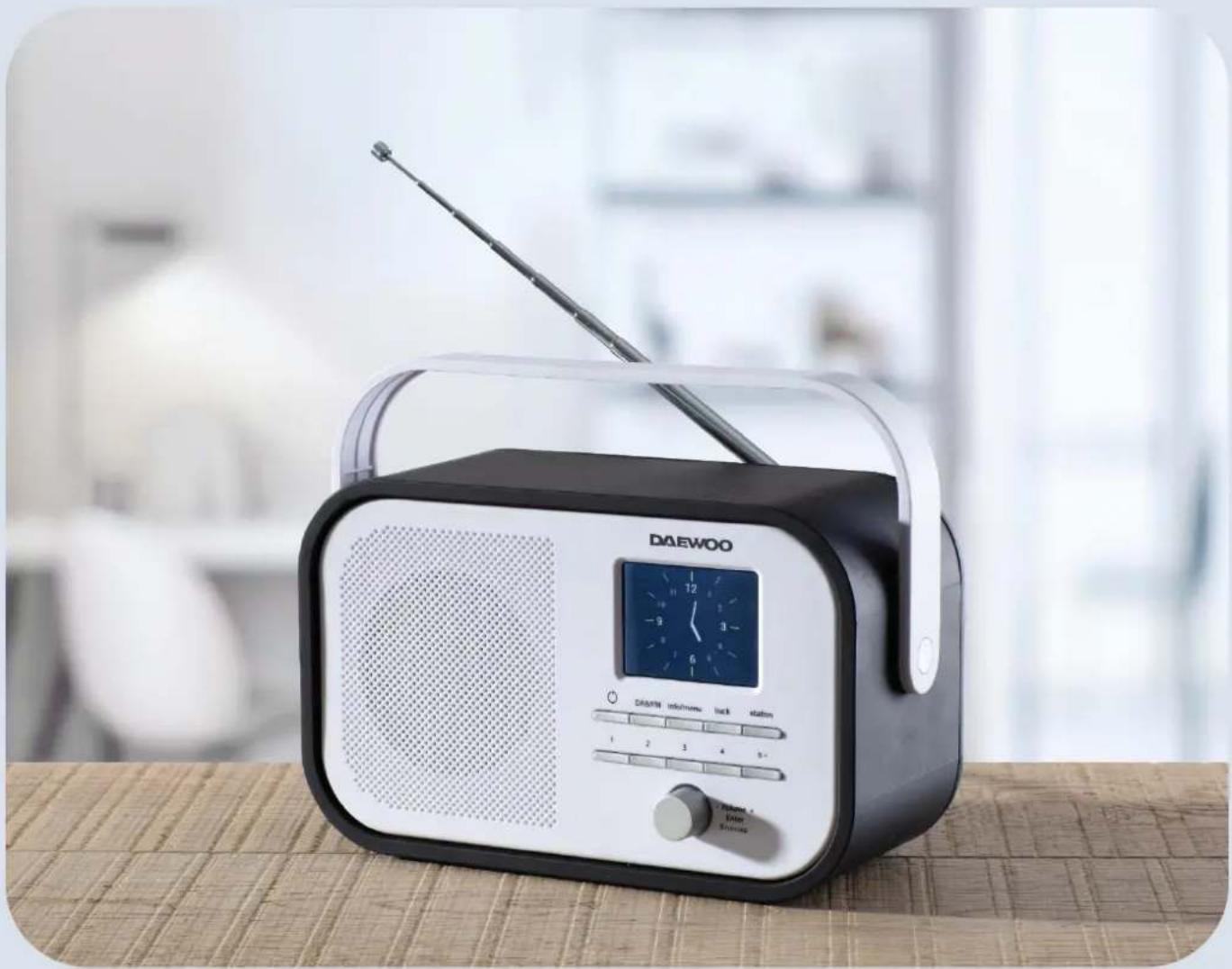 DAEWOO portable radio with a digital display and antenna, placed on a woven mat (no visible text or symbols on the device body)
