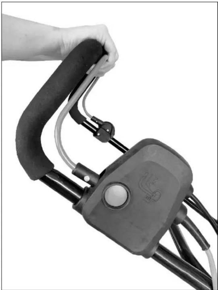 Hand holding a black cable device with a white circular button, no visible text or symbols