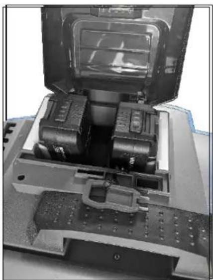 Close-up of a mechanical device with internal components and mounting holes (no visible text or symbols)