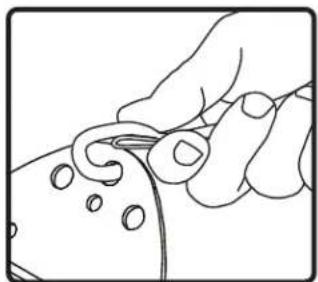 Line drawing of a hand holding a small object with circular holes, no text or symbols present