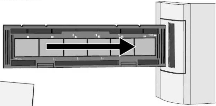 Diagram of a device interior with labeled sections and an arrow indicating direction, likely illustrating a process or layout.