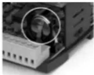 Close-up of a computer motherboard with a magnified circular inset showing internal components (no visible text or symbols)