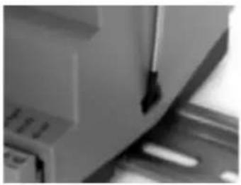 Close-up of a mechanical component with a downward arrow and flange (no visible text or symbols)