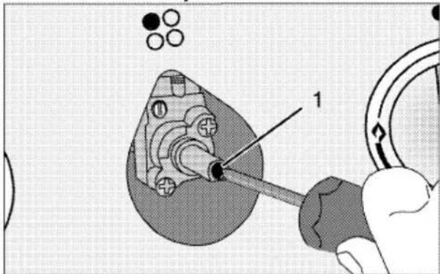 Technical diagram showing a mechanical assembly with labeled component '1' and circular components, likely illustrating a tool or procedure.