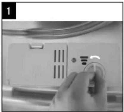 Close-up of a hand holding a circular button next to a white electronic device with ventilation slots (no visible text or symbols)
