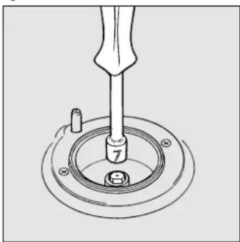 Technical line drawing of a mechanical assembly with a tool and circular base (no text or symbols)
