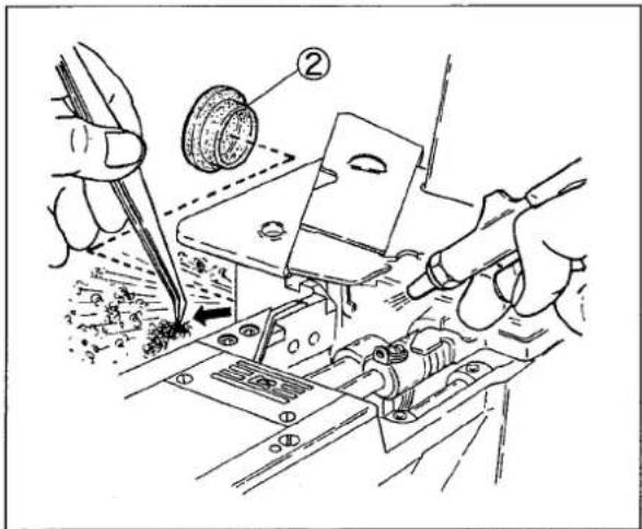 Technical diagram showing hands operating a mechanical assembly with labeled parts and tool path