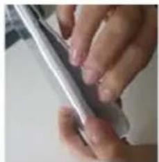Close-up of hands holding a pen or tool (no visible text or symbols)