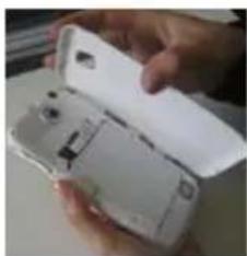 Close-up of a hand holding an open white smartphone case (no visible text or symbols)