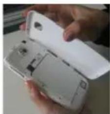 Close-up of a hand holding an open white smartphone with visible internal components (no text or symbols)