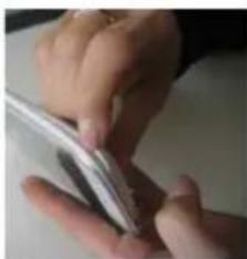 Close-up of hands holding a small electronic device (no visible text or symbols)