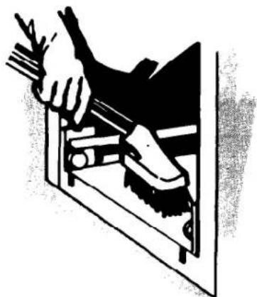 Illustration of a hand using a tool to clean or store items (no text or symbols visible)