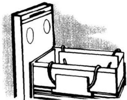 Line drawing of a wooden box with a vertical support and two circular cutouts, no text or symbols present.