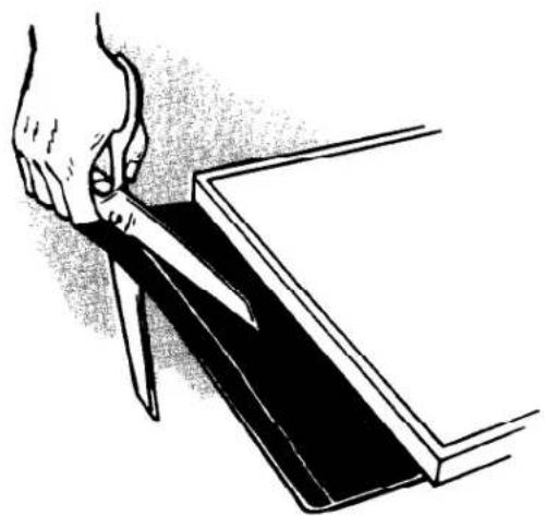 Illustration of a hand using a knife to cut or cut a rectangular object (no text or symbols visible)