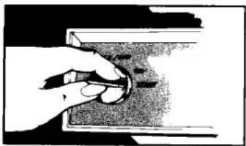 Hand holding a knob on a surface, no visible text or symbols