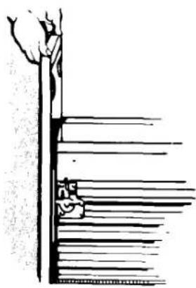 Illustration of a hand holding a ruler above a stack of books (no text or symbols visible)