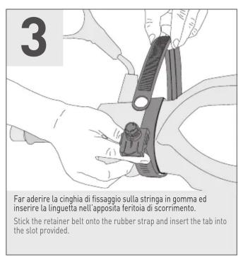 3 Far aderire la cinghi di fissaggio sulla stringa in gomma ed inserire la linguetta nell'apposta feritoia di scorrimento. Stick the retainer belt onto the rubber strap and insert the tab into the slot provided.