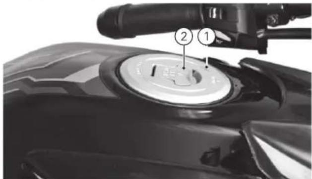 Close-up of a motorcycle's top control dial with numbered labels pointing to the dial and wheel.