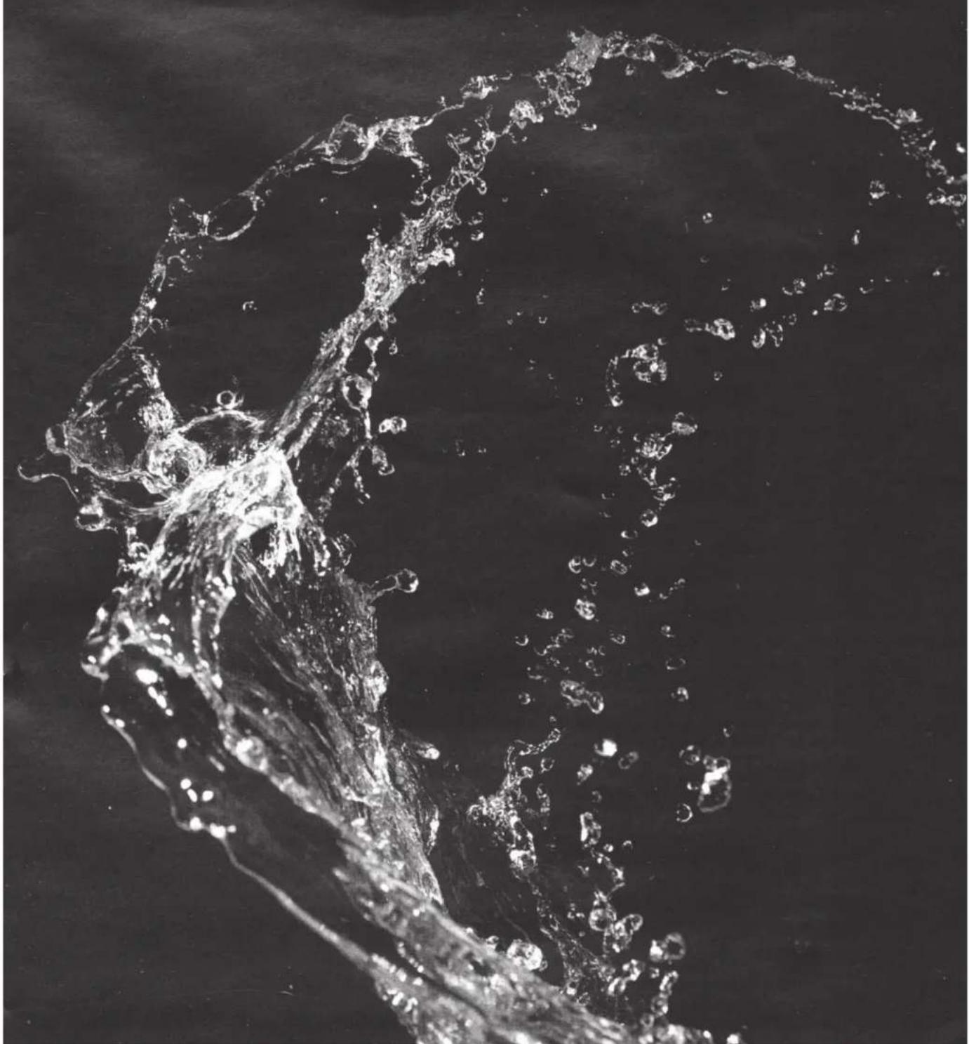 Black-and-white photo of a splashing water splash against a dark background (no text or symbols)