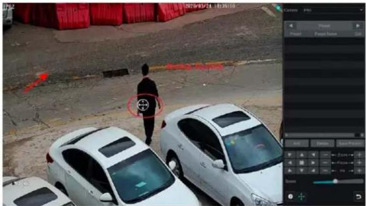 Security camera screenshot showing a person walking on a roadside with multiple cars, overlaid with red arrows and a target symbol.