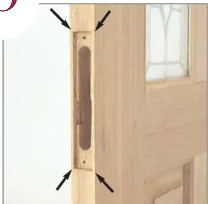 Close-up of a wooden door with a vertical scroll and arrow indicators, next to a window (no text or symbols)