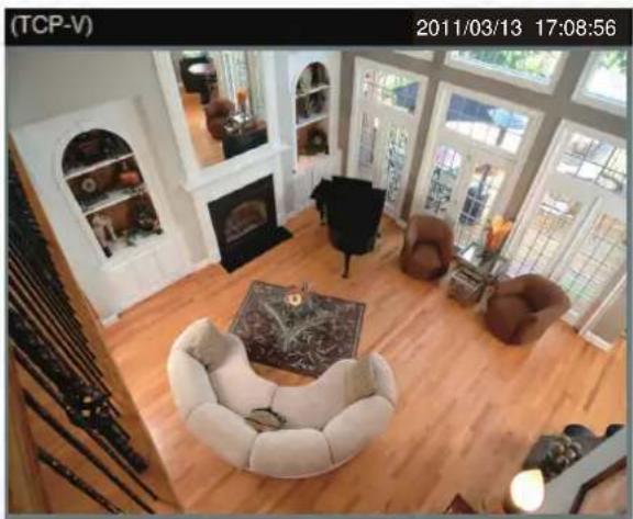 Interior view of a modern living room with wooden flooring, armchairs, and large windows (no visible text or symbols)