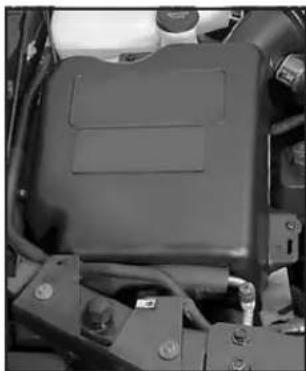 Interior view of a vehicle engine bay with visible components and wiring (no text or symbols)