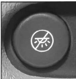 Close-up of a black circular button with a white prohibition symbol (no text or numbers visible).