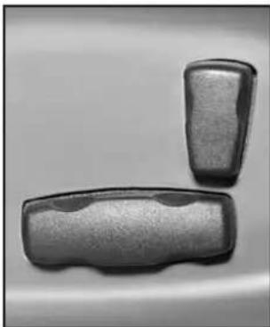 Two metallic objects with textured surfaces, possibly containers or blocks, placed side by side on a plain background (no text or symbols visible).