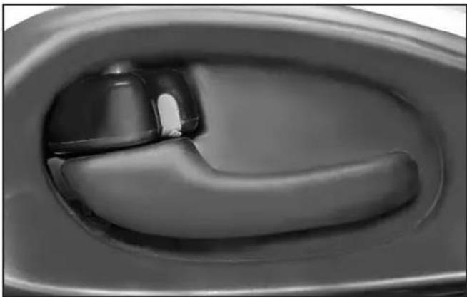 Close-up of a car door handle with a black handle and lever mechanism.