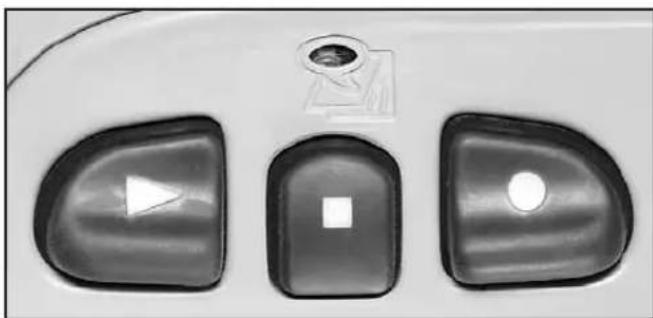 Close-up of three computer control buttons with icons (play, square, circle) on a surface, no readable text or symbols beyond basic design elements.