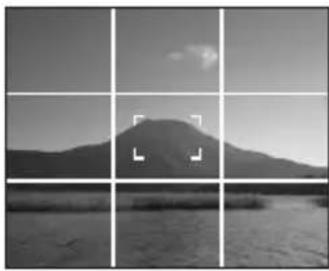 Black-and-white landscape photo of a mountain range with water and sky in the background (no text or symbols)